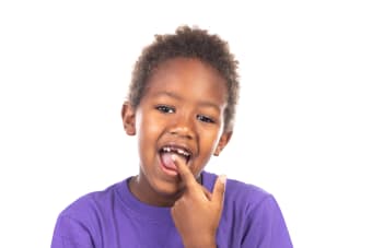 What should I do if my child swallows a tooth?